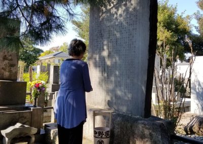 Kandi Austin praying at the Mikao Usui memorial stone